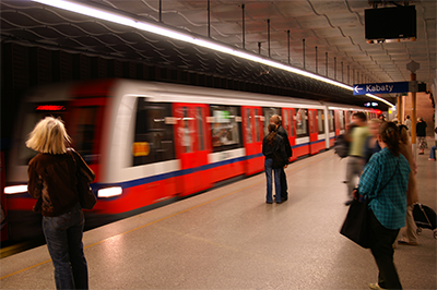 Passengers on subway platform as train passes by
