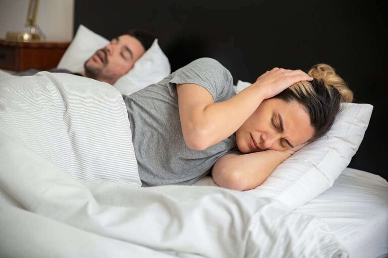 woman cannot sleep because of husbands snoring