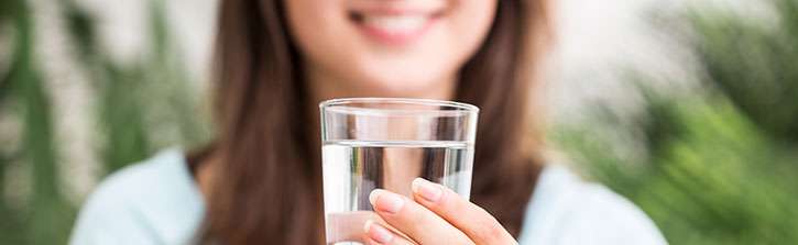 Woman holding a glass of water