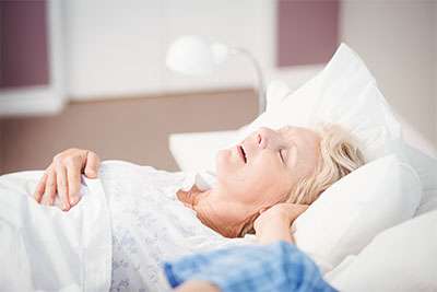 Woman snoring with sleep apnea