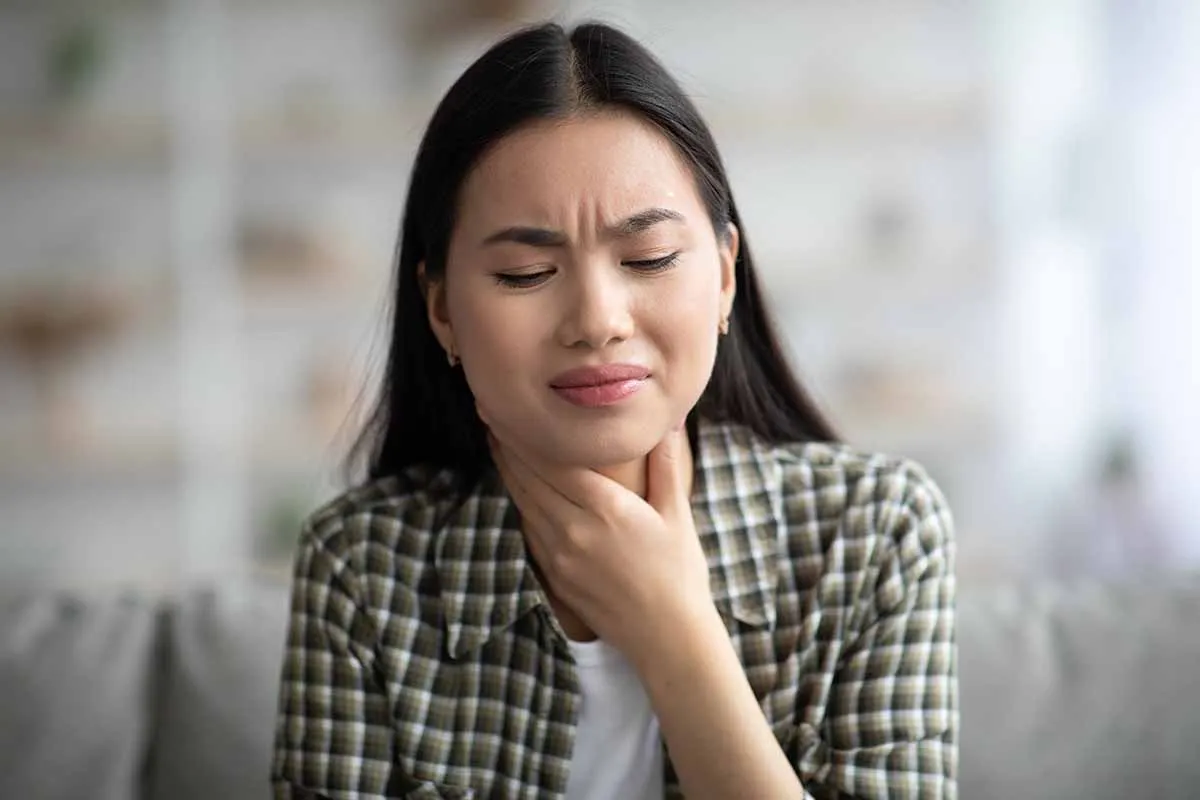 woman with throat irritation from post nasal drip