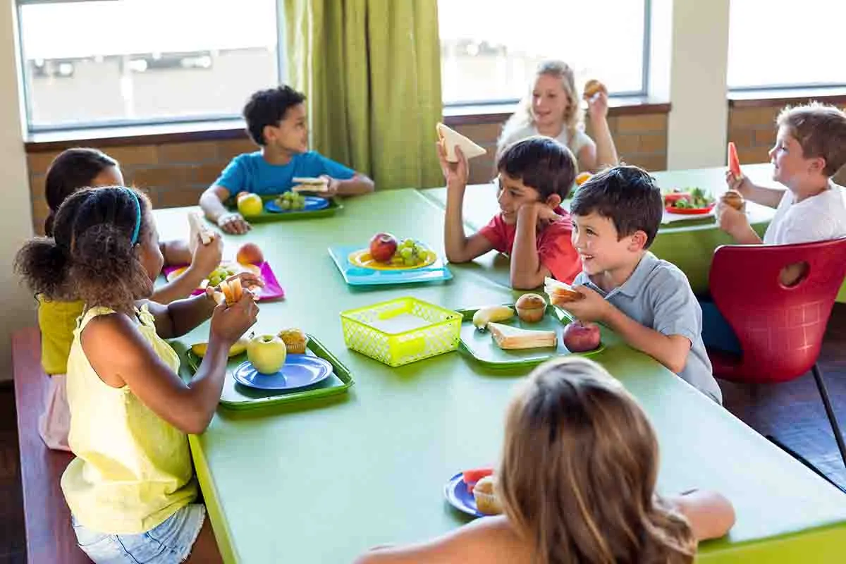 children enjoying lunch in school cafeteria