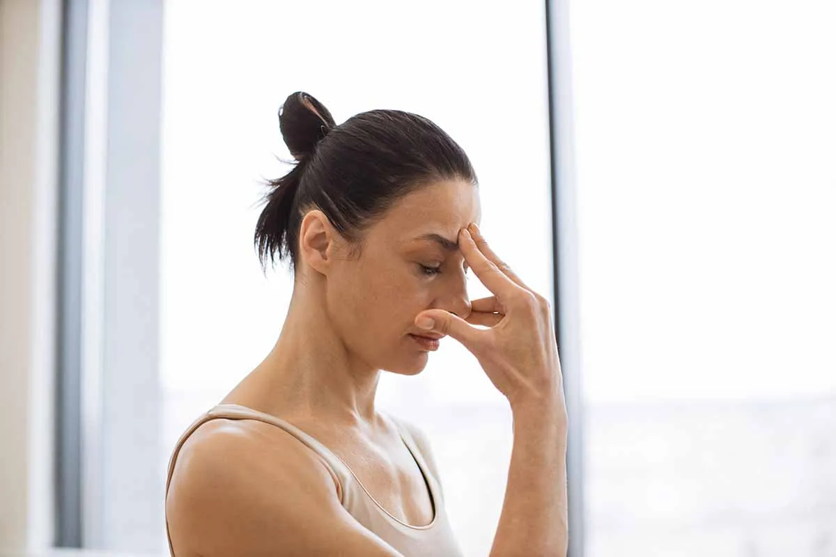 woman suffering with facial pressure and pain from sinus headache