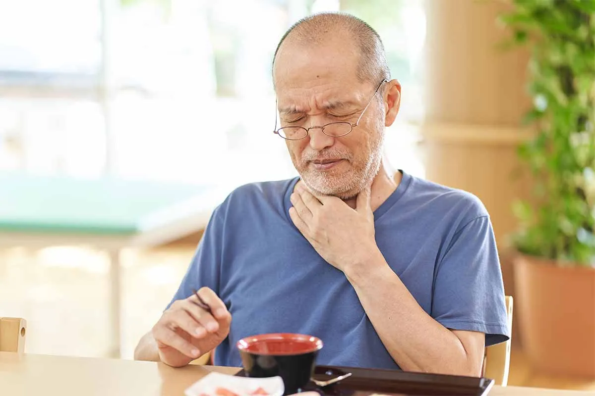 Senior Man Suffering From Dysphagia
