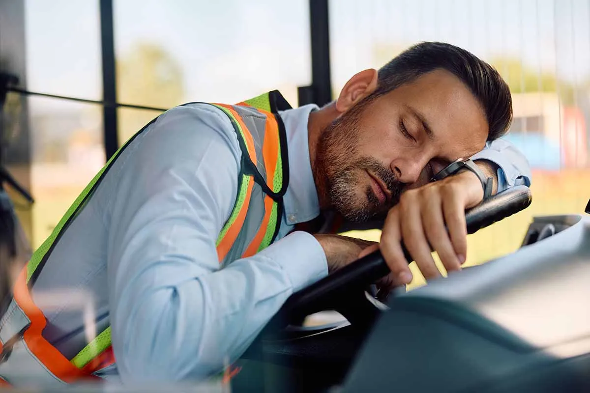 exhausted bus driver with sleep apnea napping in vehicle cabin